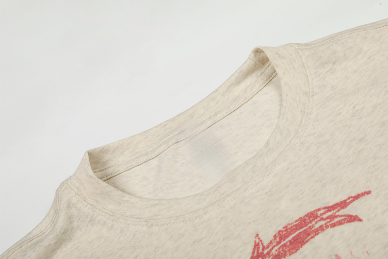 Close-up of cream tee neckline and upper chest in soft heathered cotton