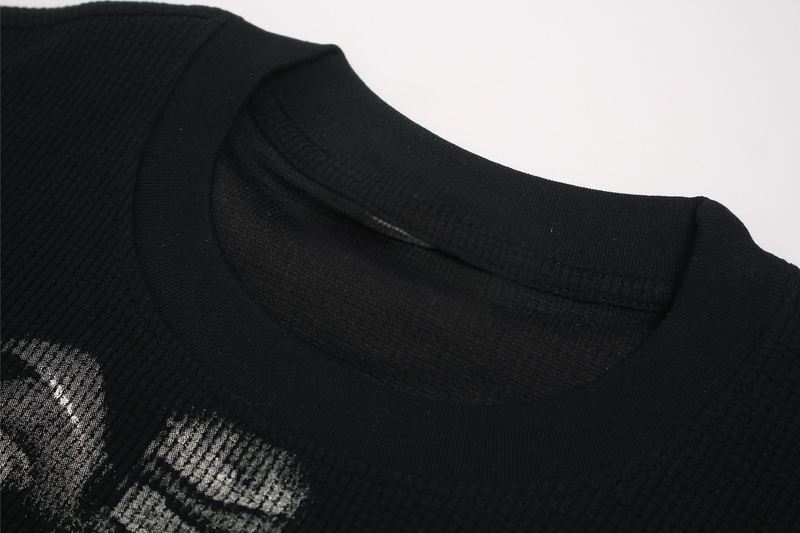 Black streetwear T-shirt with ribbed crew neck and white skeleton ribcage graphic print on the chest
