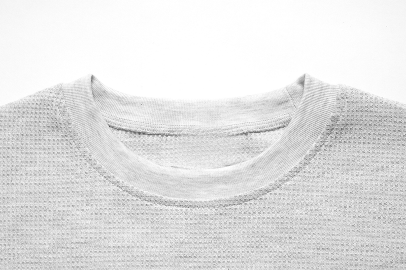 Close-up of white waffle-knit crew neck collar and ribbed neckline