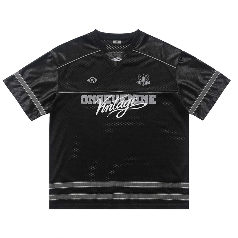Black oversized varsity mesh jersey tee with satin shoulder panels, sporty graphics, and vintage streetwear styling