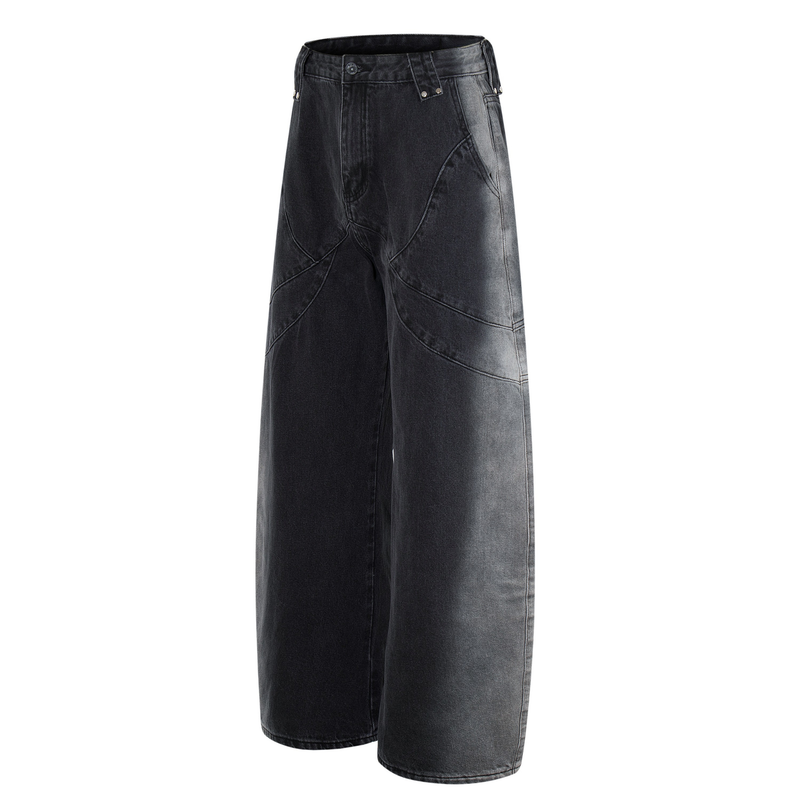 Three-quarter front view of washed black wide-leg jeans with curved seam panels