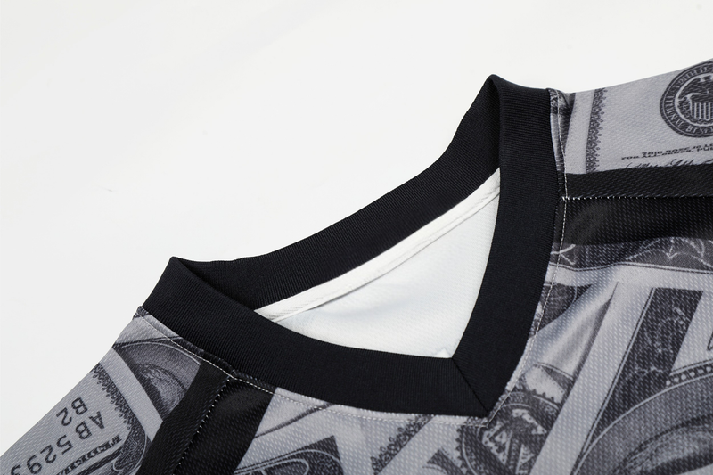 Black mesh football jersey with dollar bill print and ribbed V-neck trim, shown in a close-up streetwear detail