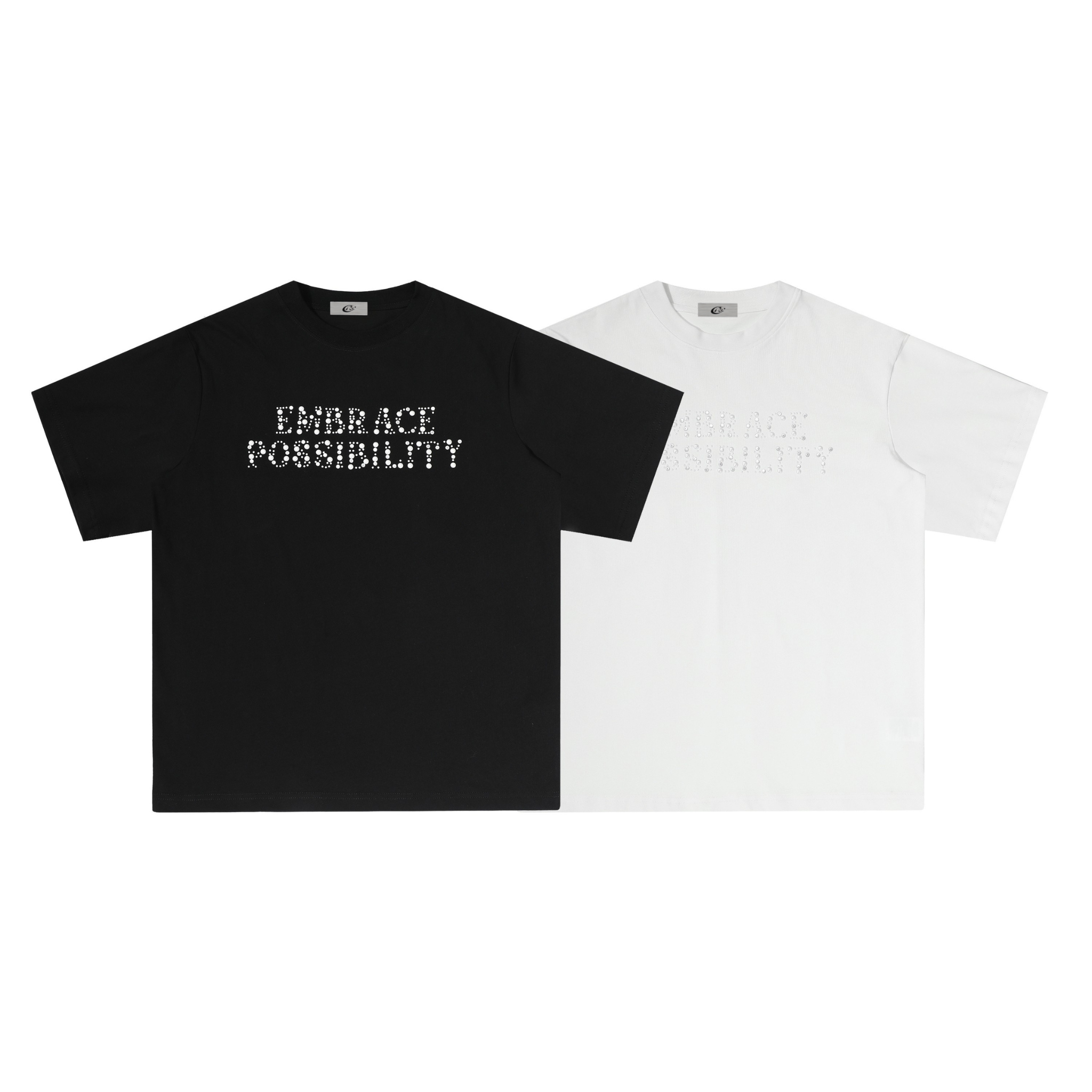 Black oversized t-shirt with rhinestone dot lettering reading Embrace Possibility on the chest, laid flat on white background