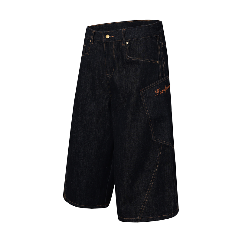 Angled front view of dark indigo denim jorts with side script detail and plaid patchwork panel