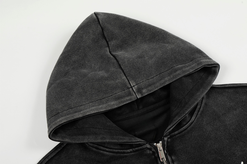 Close-up of black hoodie hood with stitched seam and faded washed texture