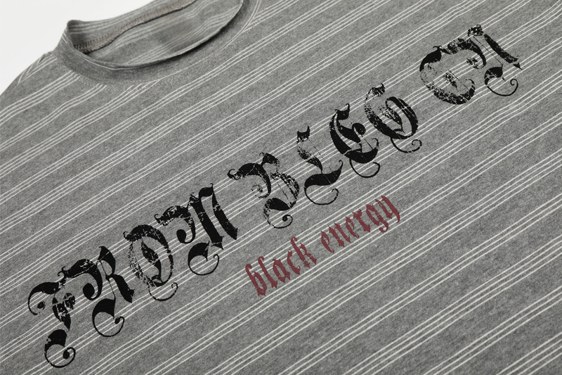 Close-up of Gothic chest logo and red black energy text on gray striped long sleeve tee