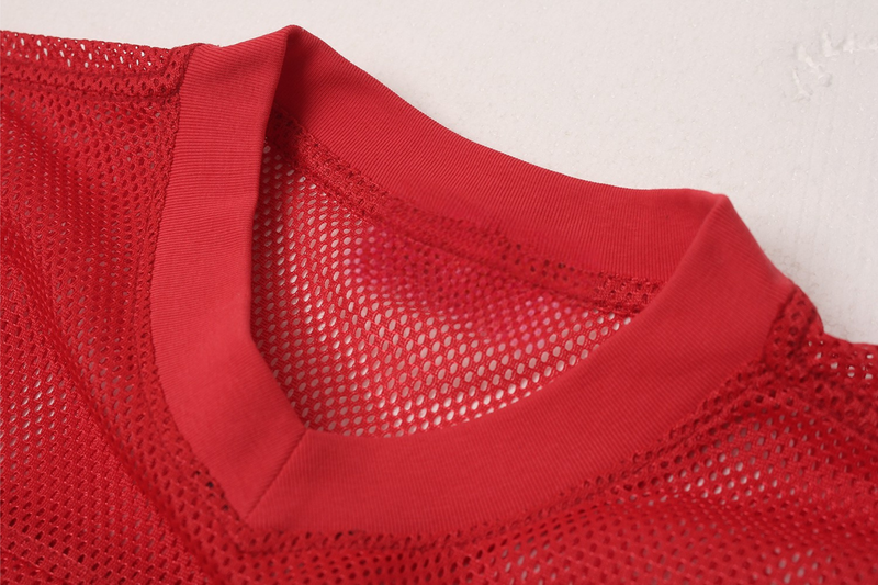 Red oversized mesh football jersey with ribbed crew neck and breathable perforated fabric close-up