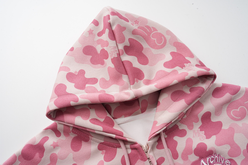 Close-up of pink camo hoodie hood and front zipper with embroidered logo