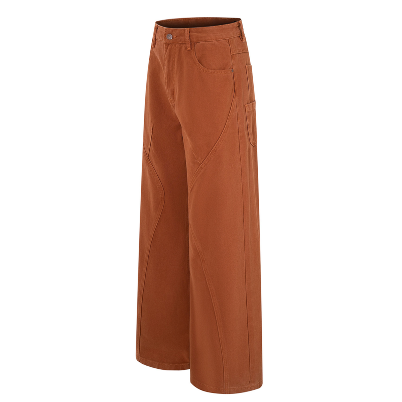 Side view of rust brown wide-leg jeans showing curved panel seams and cargo-style pocket