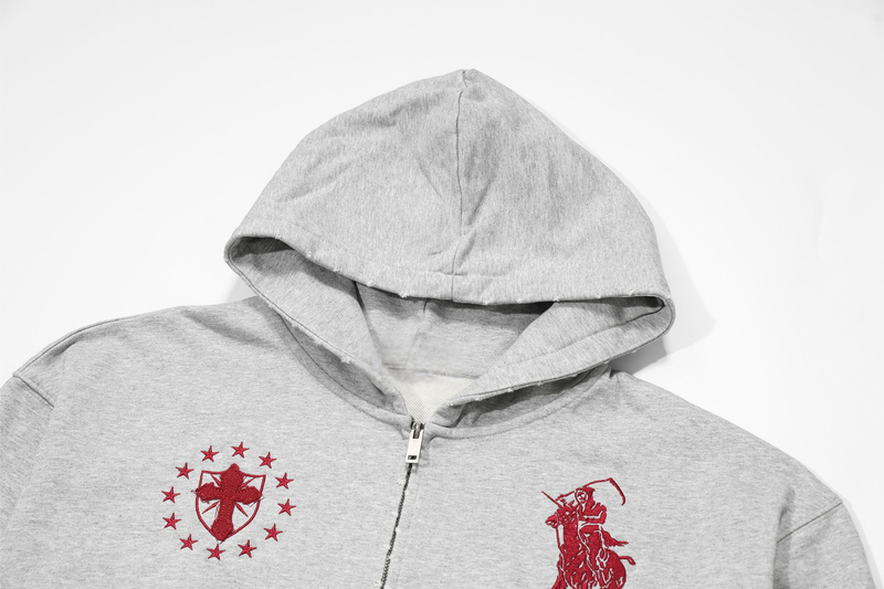 Close-up of light gray hoodie hood and upper front with red embroidered crest details