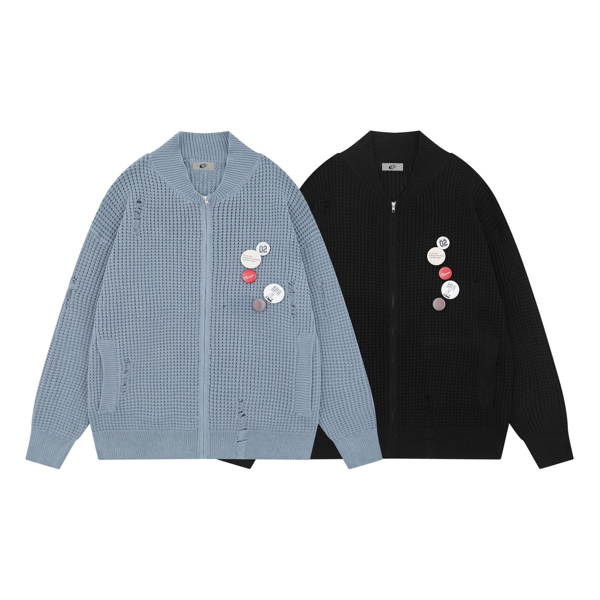 Dusty blue waffle-knit zip cardigan with distressed details and decorative pin badges on the chest