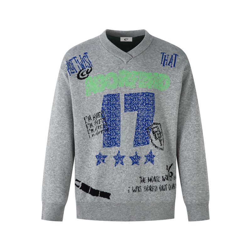 Gray V-neck knit sweater with graffiti-style graphic text and blue, green, and black prints on the front