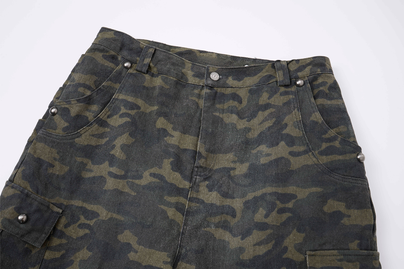 Close-up of camo cargo pants waistband with belt loops, button closure, and front pockets
