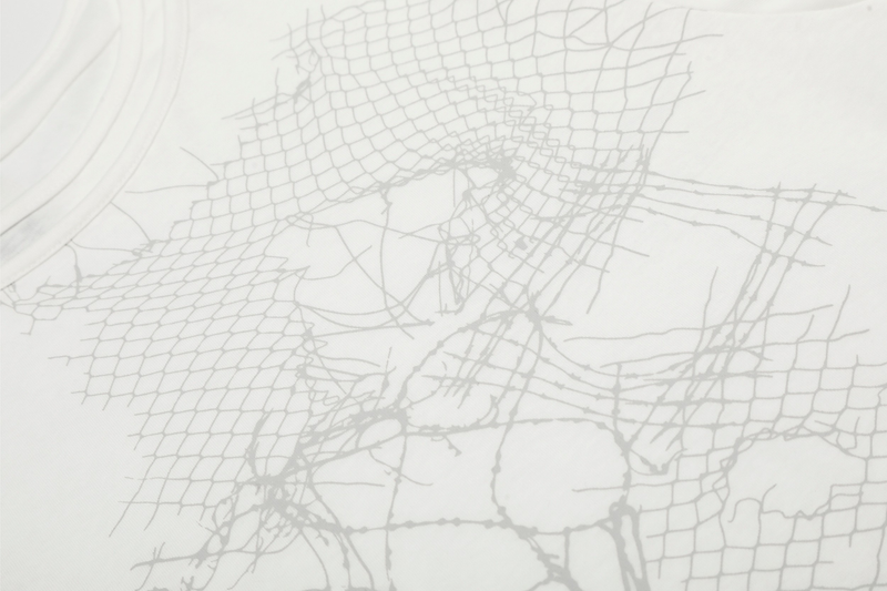 Close-up of white tee graphic with mesh pattern and cracked-line design