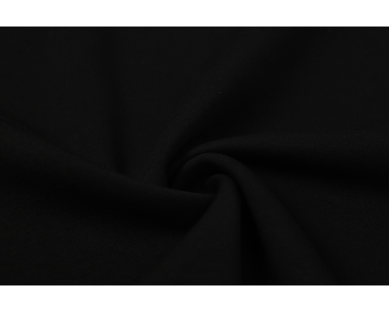 Close-up of plain black fabric with soft gathered folds