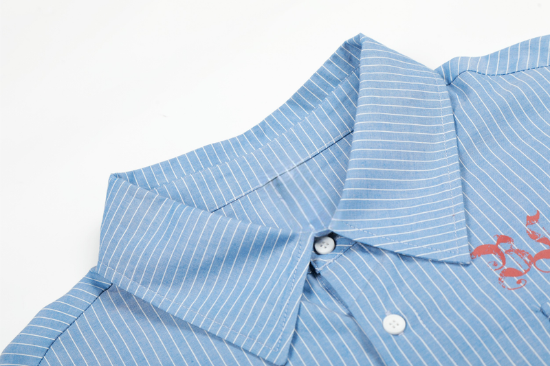 Close-up of blue striped shirt collar and top button with red graphic print nearby