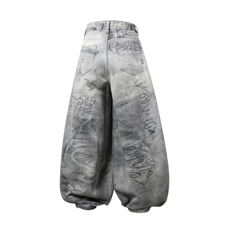 Back view of gray washed wide-leg denim pants with graffiti print and large patch pockets