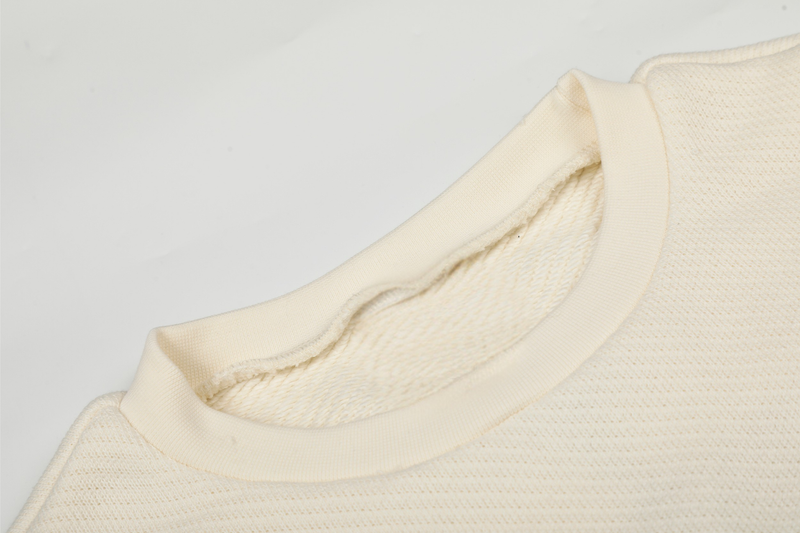 Close-up of cream sweatshirt collar and inside fleece texture