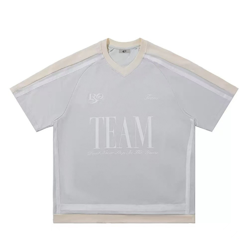 Oversized white varsity mesh tee with beige trim, V-neck and TEAM graphic on the front