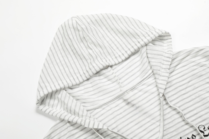 Close-up of white striped hood with visible seam and drawstring opening