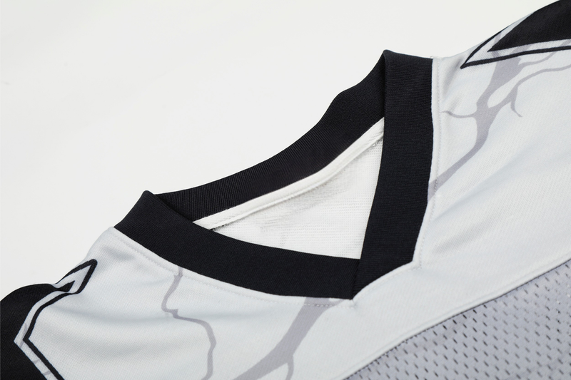 Black and white mesh football jersey with portrait graphic and V-neck collar, shown in close-up detail