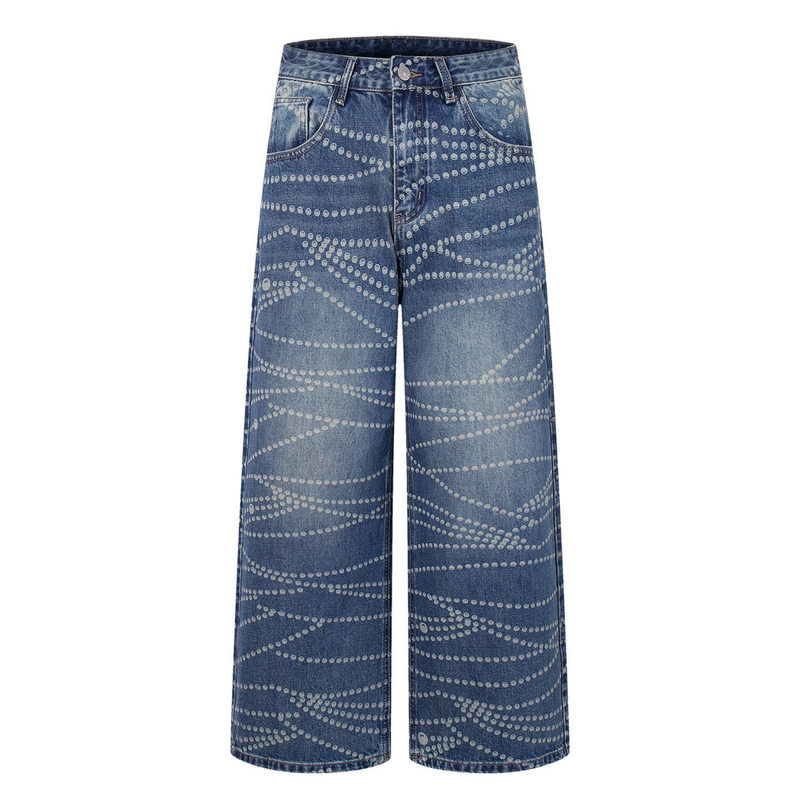 Front view of wide-leg blue denim pants with allover dot pattern and faded wash