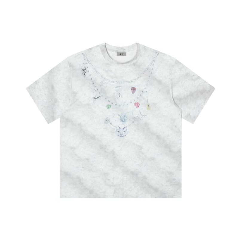 White tie-dye graphic tee with layered charm necklace print and pastel pendants on a relaxed streetwear shirt