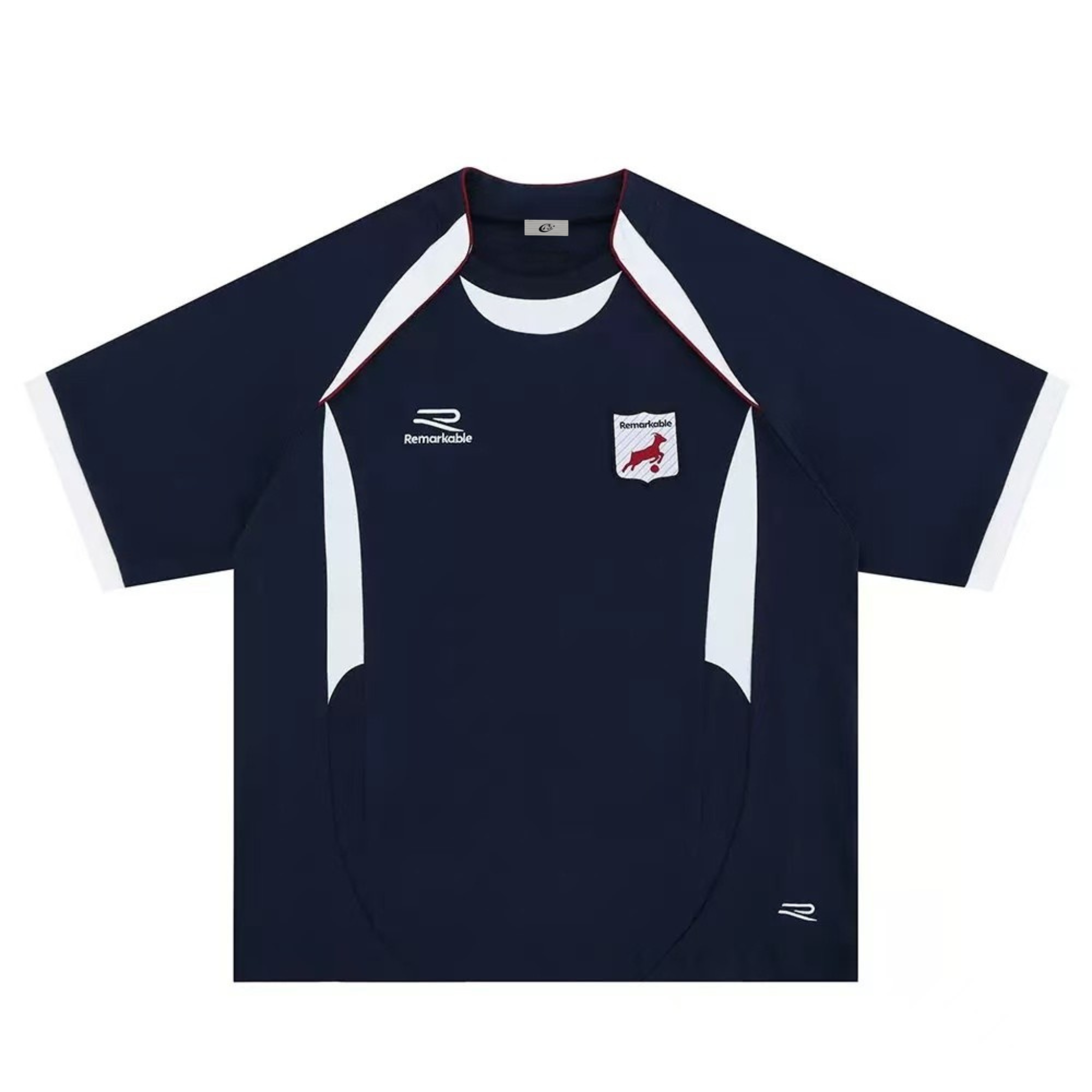 Flat lay of navy oversized football jersey with white contrast panels, red piping, and embroidered Remarkable shield crest on
