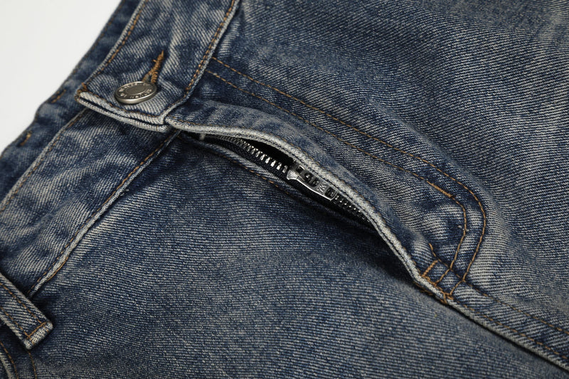 Close-up of zip fly and front waist on faded distressed jeans