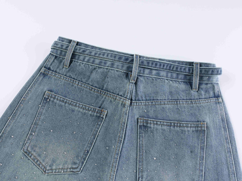 Light blue denim back waist close-up with belt loops and patch pockets