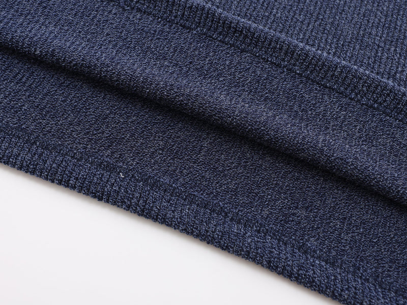Close-up of navy ribbed knit side seam and hemline