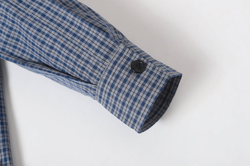 Plaid sleeve cuff with black button and stitched hem detail
