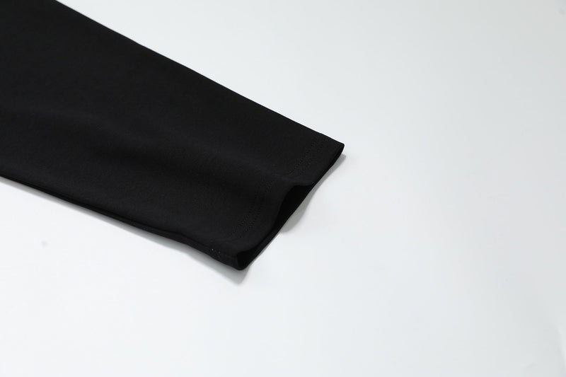 Close-up of black sleeve cuff on long sleeve polo shirt