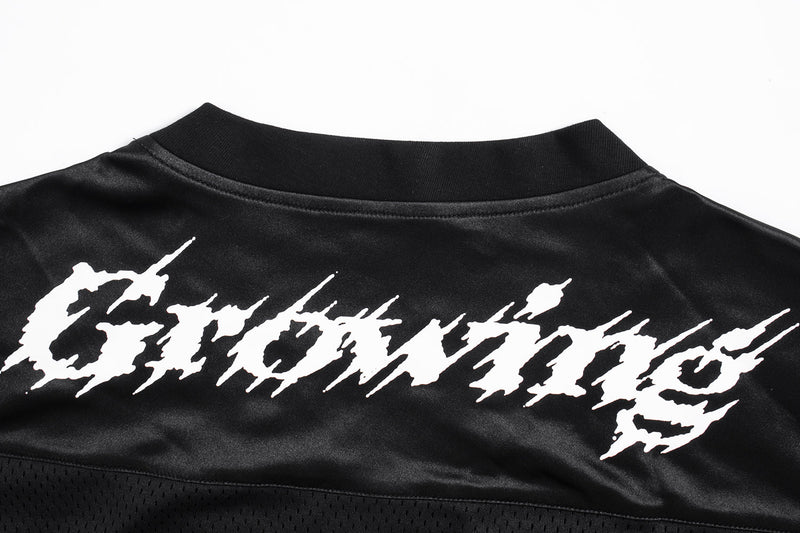 Close-up of the back yoke showing white Gothic Growing text on black satin fabric