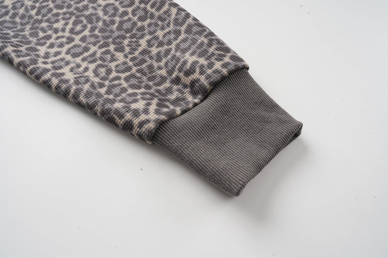 Leopard print sleeve with ribbed gray cuff close-up