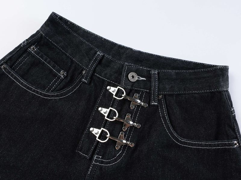 Close-up of the front waistband and triple buckle closures on dark wash denim shorts