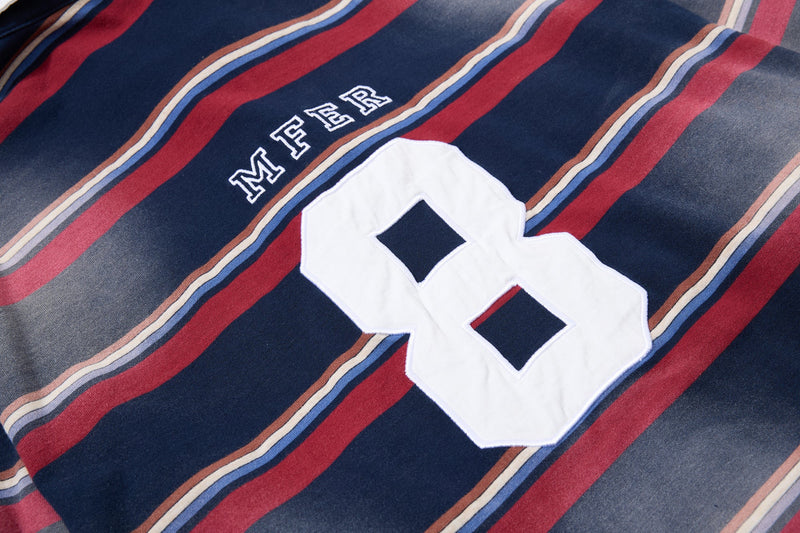 Close-up of back chest on striped rugby polo with MFER lettering and large white number 8 patch