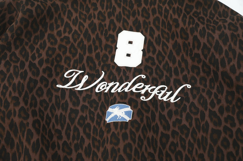 Chest close-up of brown leopard print hoodie with white "8" and "Wonderful" embroidery
