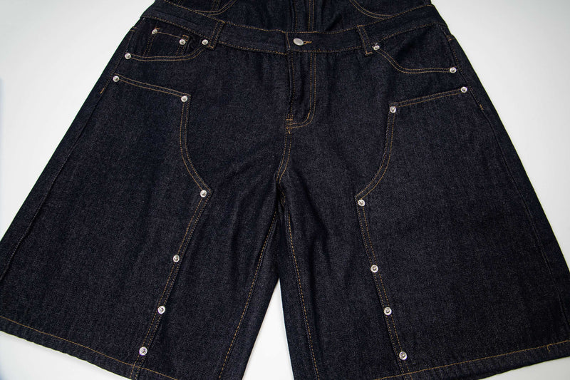 Front view of wide fit denim shorts with double waist panel and long leg openings