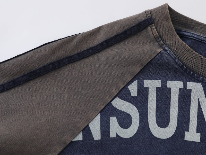 Close-up of raglan shoulder seam and ribbed neckline in blue and tan