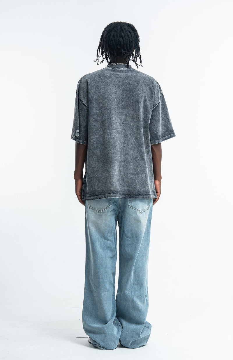 Vintage washed gray oversized streetwear tee worn with light blue baggy jeans, back view on model