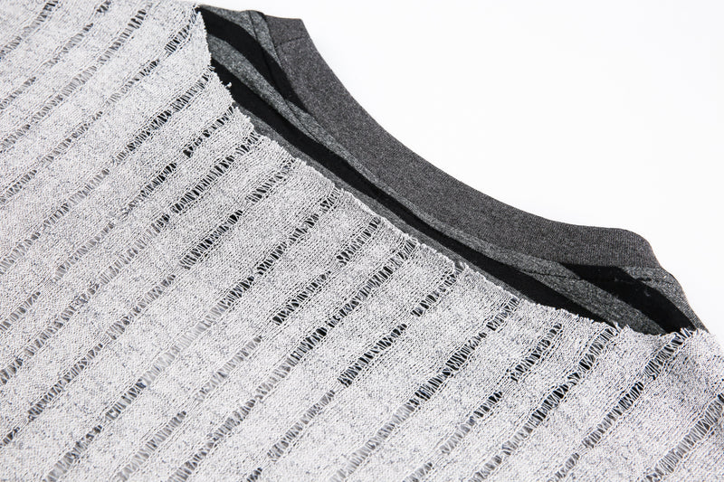 Close-up of gray ribbed knit neckline with black trim