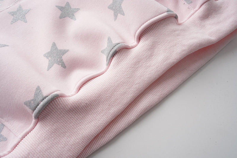 Pink hoodie hem close-up with ribbed cuff and star print