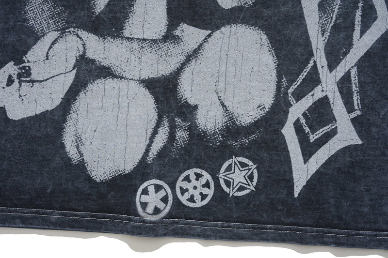 Close-up of a vintage washed black gothic graphic T-shirt with oversized distressed white print and star icons