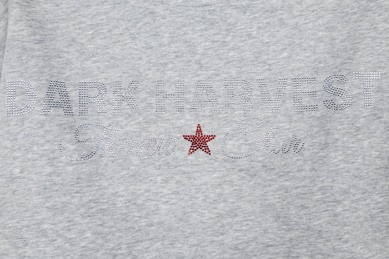 Close-up of Dark Harvest Threw Star rhinestone graphic centered on heather gray tee