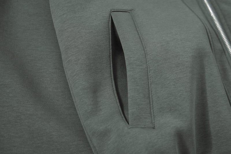 Close-up of front pocket opening on dark green hoodie