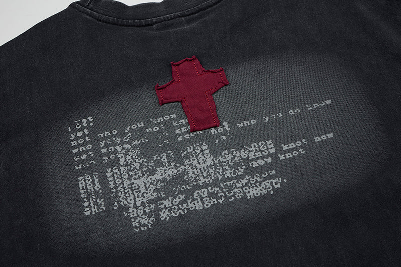 Black sleeveless distressed T-shirt with red cross graphic and faded white print detail
