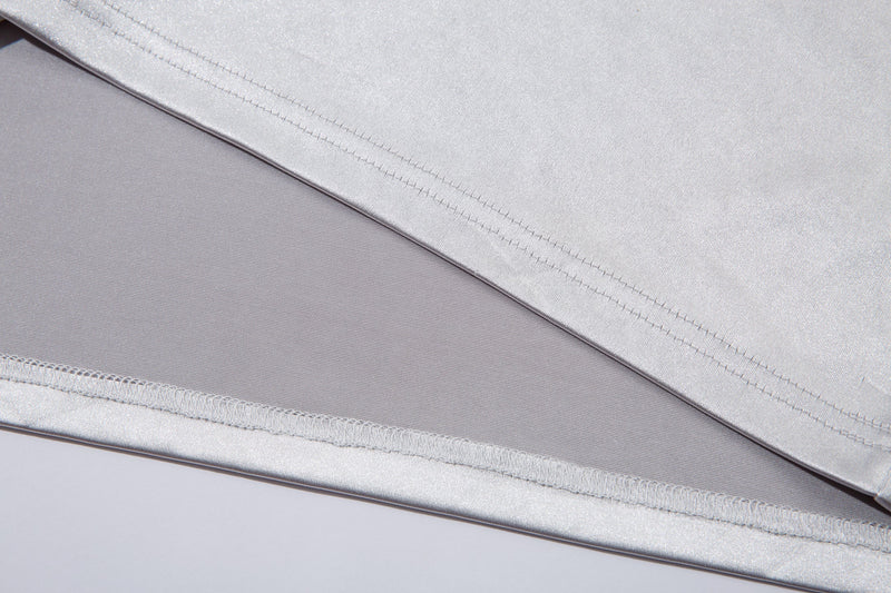 Close-up of white jersey tee hem stitching and layered fabric
