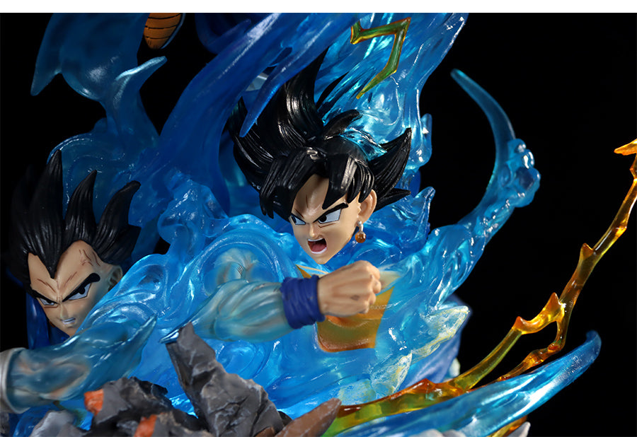 The Seakoff Goku Transformations Collectible Figure from Dragon Ball Super features two black-haired characters in dynamic poses with swirling blue energy and orange flames, capturing an intense action scene. The 46cm figure includes interchangeable heads and glowing effects.