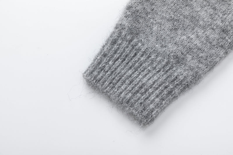 Close-up of gray ribbed sleeve cuff on fuzzy knit cardigan